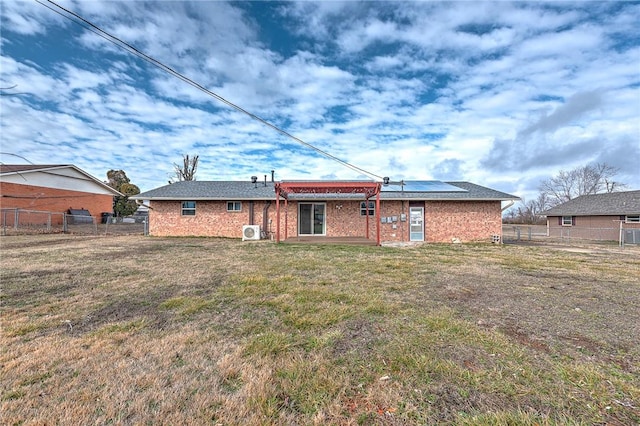 913 17th St, Rogers, AR 72758 - back of house featuring a yard and solar panels
