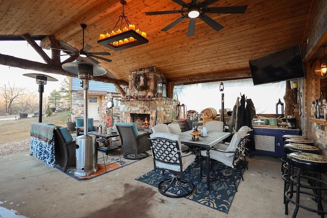 view of patio / terrace featuring ceiling fan and an outdoor stone fireplace