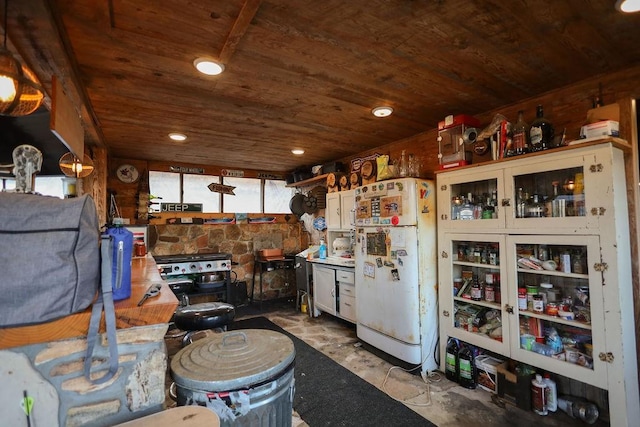 kitchen featuring white refrigerator, white cabinetry, and wood ceiling