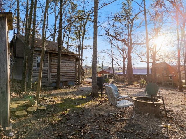 view of yard with a fire pit