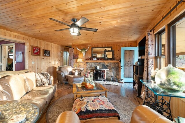 living room featuring wood ceiling, wooden walls, ceiling fan, and hardwood / wood-style flooring