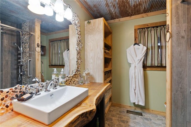 bathroom featuring an enclosed shower, vanity, and wooden ceiling