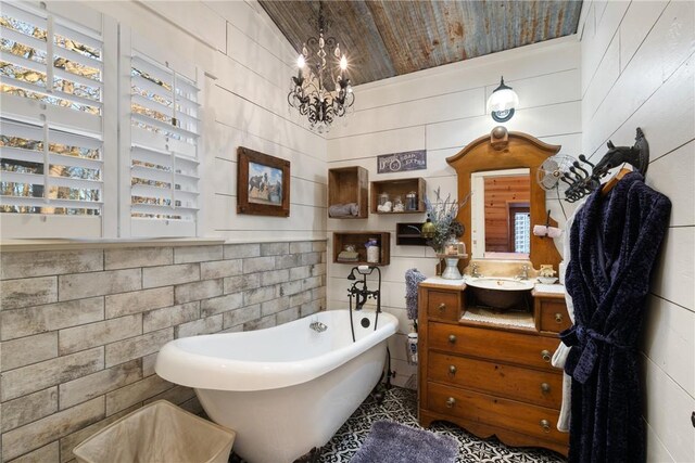 bathroom featuring vanity, a tub to relax in, wood ceiling, and an inviting chandelier