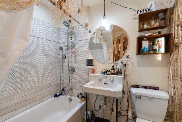 full bathroom with shower / tub combo, toilet, and sink