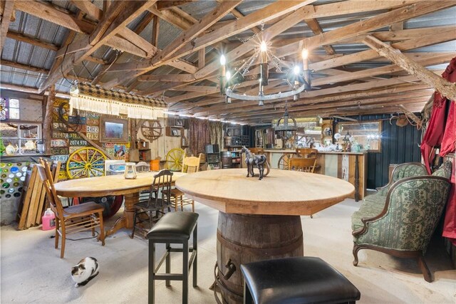 dining area featuring concrete flooring and bar