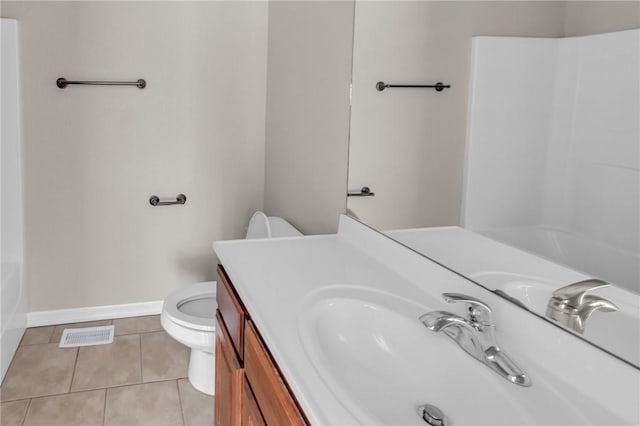 bathroom featuring vanity, tile patterned floors, and toilet