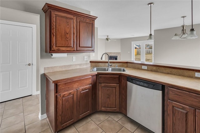 kitchen with sink, dishwasher, light tile patterned flooring, decorative light fixtures, and kitchen peninsula