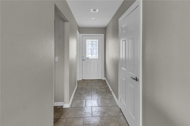 doorway to outside featuring light tile patterned floors