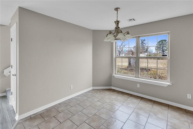 unfurnished dining area with light tile patterned flooring and a notable chandelier