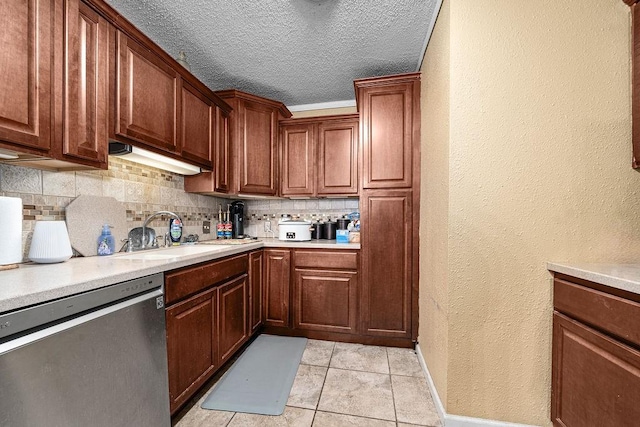 kitchen with dishwasher, sink, light tile patterned floors, and backsplash