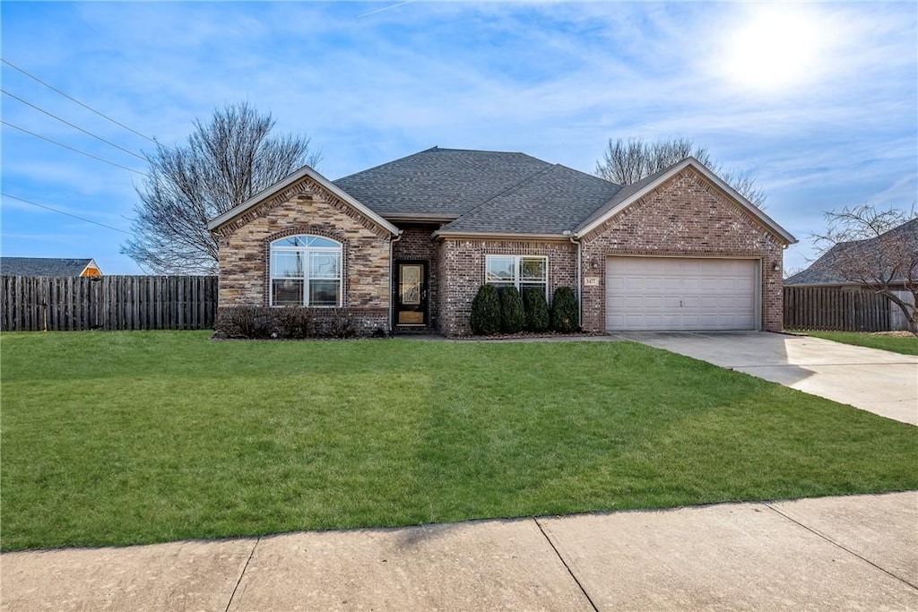 ranch-style house with a garage and a front yard