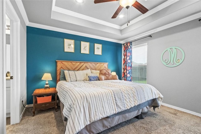 bedroom with ceiling fan, ornamental molding, a raised ceiling, and carpet