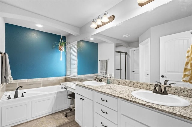 bathroom featuring independent shower and bath and vanity