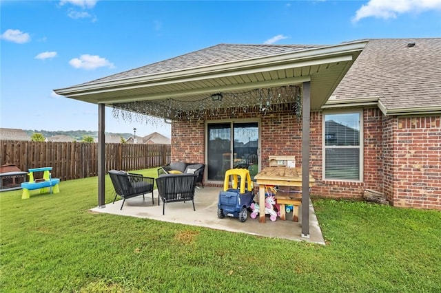 rear view of property featuring a patio, an outdoor living space, and a lawn