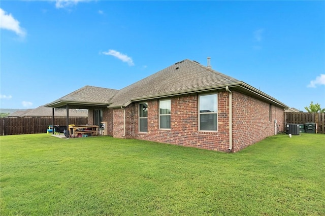 back of property featuring a patio, a yard, and central air condition unit