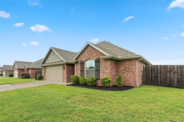 view of front of house featuring a garage and a front lawn