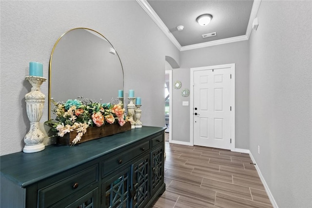 entryway featuring ornamental molding