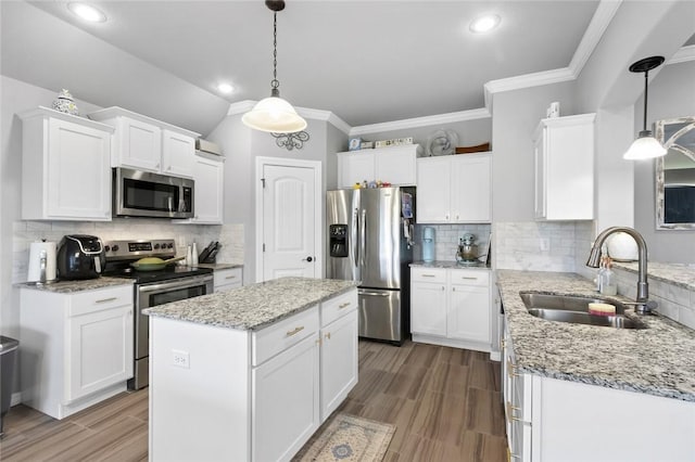 kitchen featuring white cabinetry, stainless steel appliances, sink, and hanging light fixtures