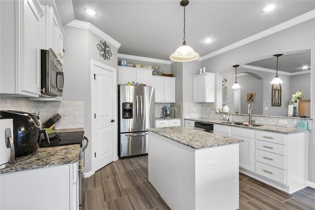 kitchen featuring white cabinetry, sink, stainless steel appliances, and a kitchen island