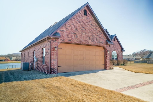 view of home's exterior featuring brick siding, a yard, concrete driveway, central AC unit, and a garage