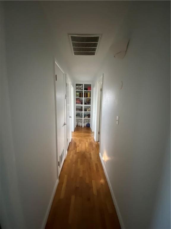 hall with hardwood / wood-style flooring