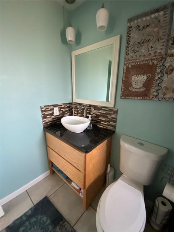 bathroom with vanity, backsplash, tile patterned floors, and toilet