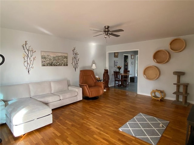 living room with ceiling fan and hardwood / wood-style floors