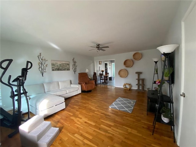 living room featuring ceiling fan and hardwood / wood-style floors