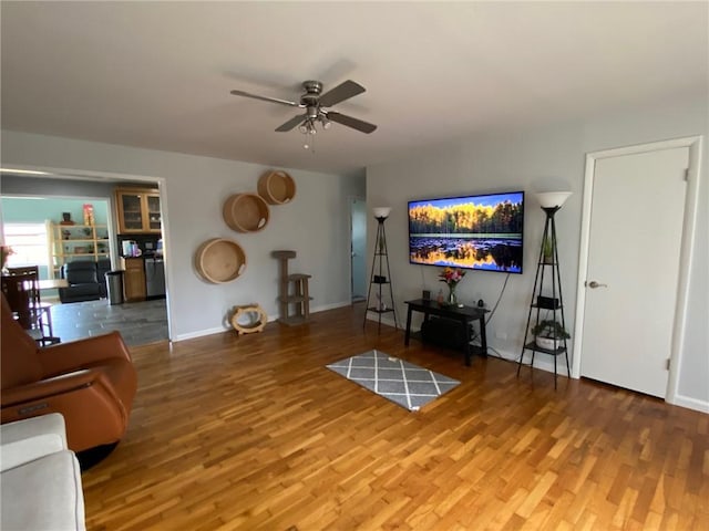 living room with hardwood / wood-style floors and ceiling fan