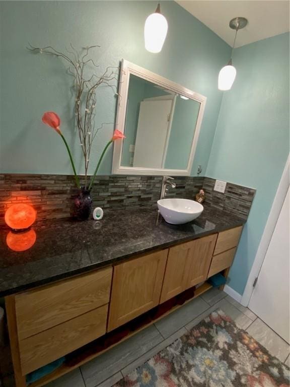 bathroom with vanity, tile patterned flooring, and tasteful backsplash