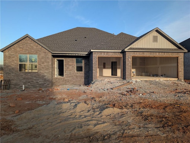 view of front facade with a garage and brick siding