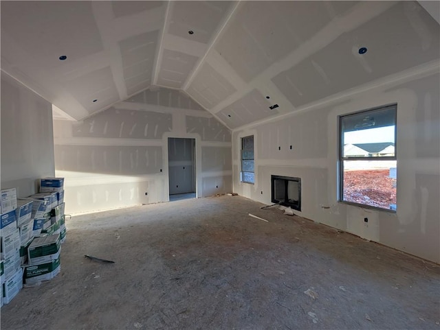 unfurnished living room with lofted ceiling and a fireplace
