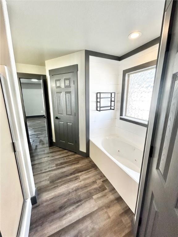 bathroom featuring wood-type flooring and a washtub