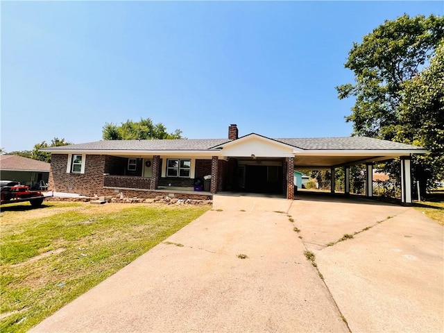 single story home featuring a carport and a front yard