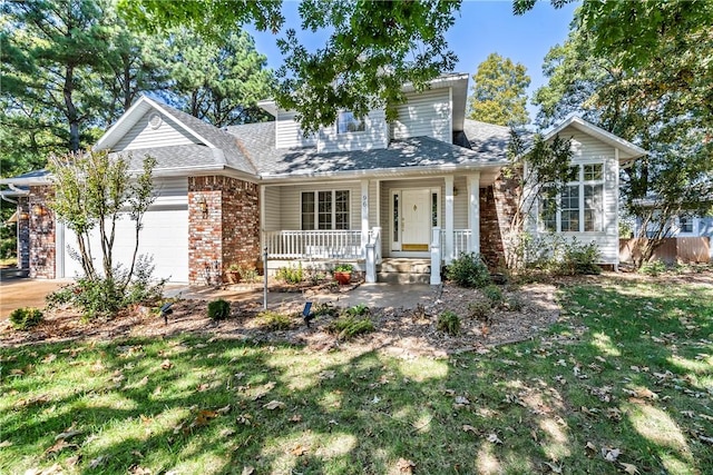 view of front of property with a porch, a garage, and a front yard