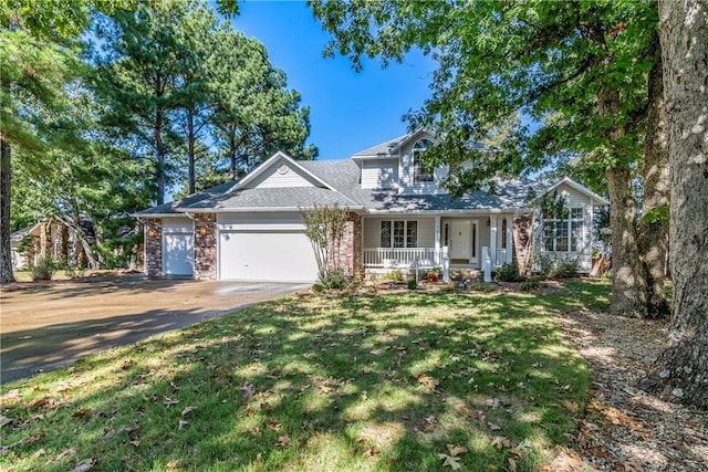 view of front of property with a garage, a front lawn, and covered porch