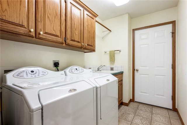 washroom with independent washer and dryer, cabinets, and sink