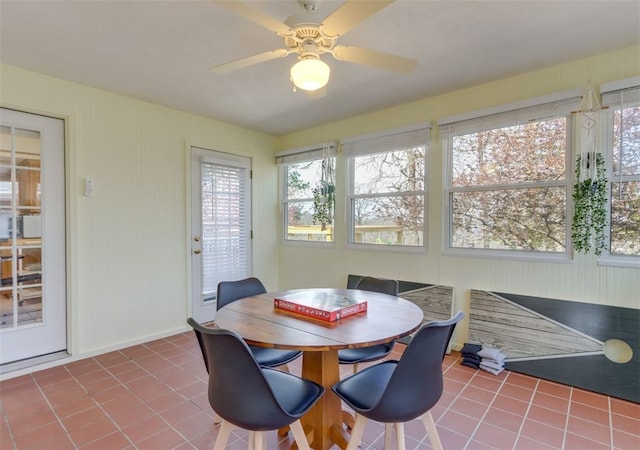 tiled dining space with ceiling fan