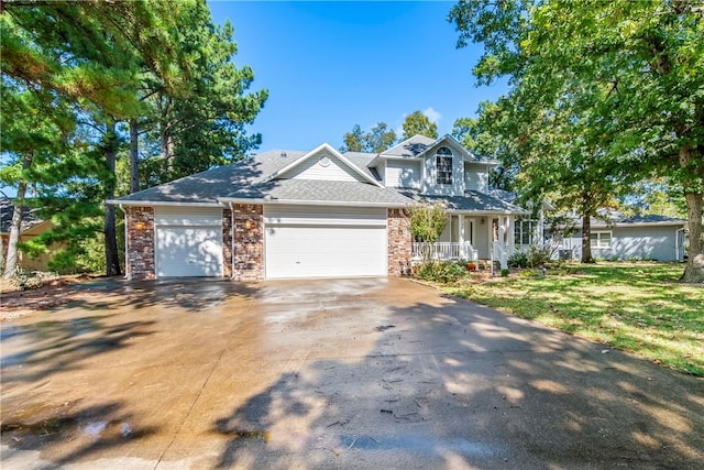 view of front facade with a garage, covered porch, and a front yard