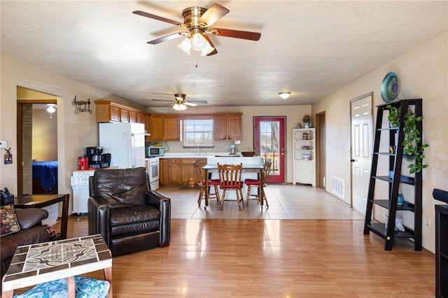 living room with sink and light hardwood / wood-style flooring