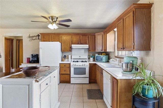 kitchen with ceiling fan, sink, light tile patterned floors, and white appliances