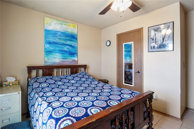 tiled bedroom featuring ceiling fan