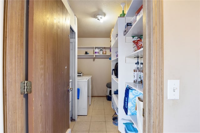 laundry room featuring independent washer and dryer and light tile patterned floors