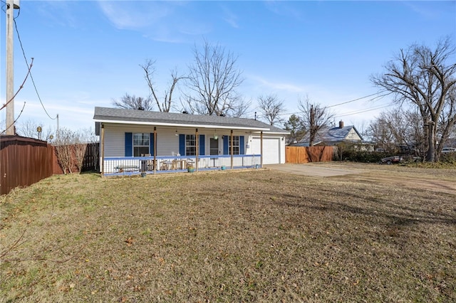 ranch-style house featuring a porch, a garage, and a front yard