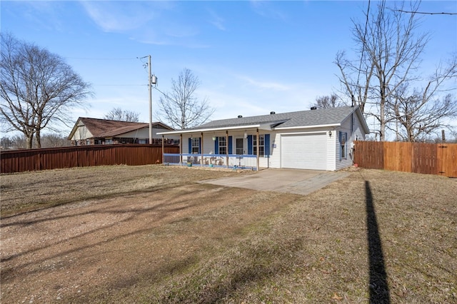 view of front of house featuring a garage, covered porch, and a front lawn