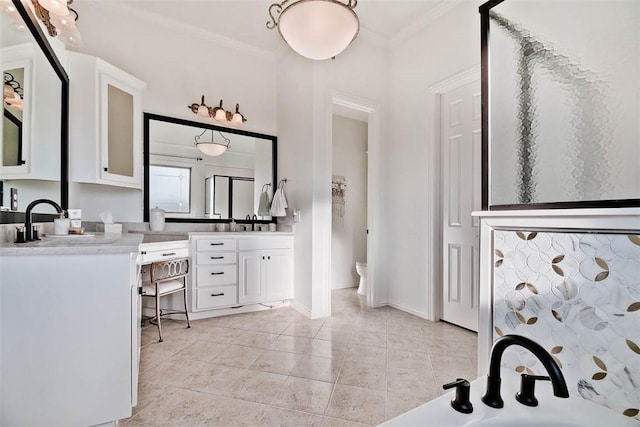 bathroom featuring tile patterned flooring, vanity, ornamental molding, a shower with shower door, and toilet