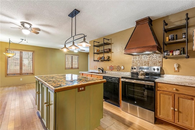 kitchen featuring premium range hood, pendant lighting, black dishwasher, stainless steel range with electric stovetop, and a center island