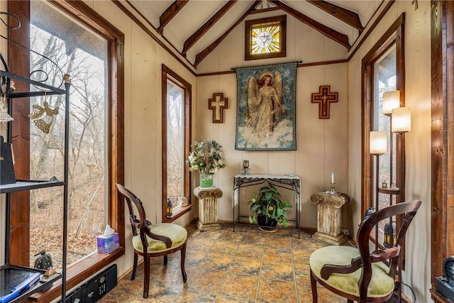 sitting room featuring plenty of natural light and lofted ceiling with beams