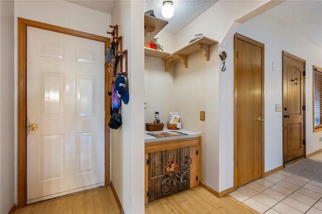 interior space with a textured ceiling and light hardwood / wood-style floors