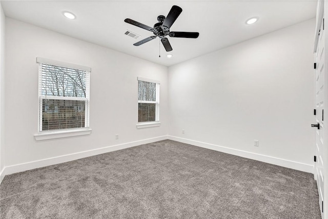 carpeted spare room with ceiling fan